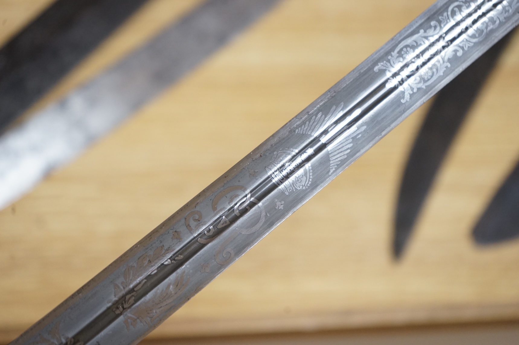 World War I Scottish infantry officer’s undress sword, etched and polished regulation blade with crowned GVR cipher and regulation cruciform hilt, in its leather scabbard